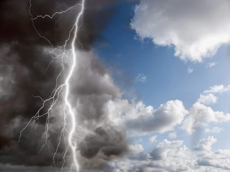 blue sunny sky and black clouds with lightning