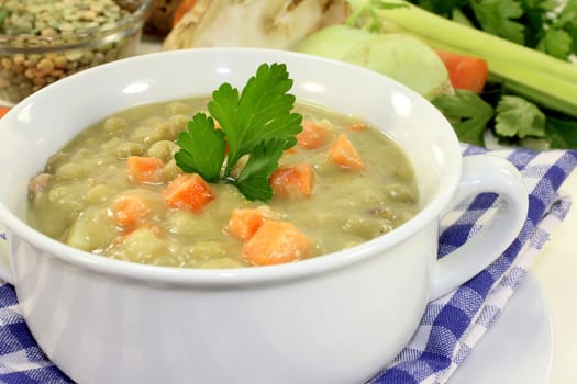 a white cup of pea stew and parsley
