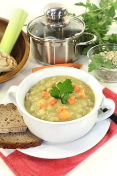 a white cup of pea stew and parsley