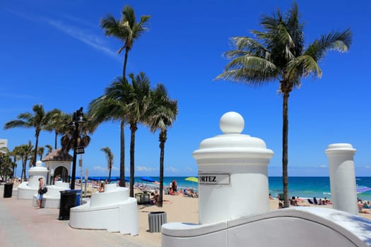 FORT LAUDERDALE, FLORIDA - APRIL 8, 2013: Many people relaxing, suntanning enjoying spring break at the popular tropical public beach on a warm and sunny day near Cortez Street and State Road A1A.