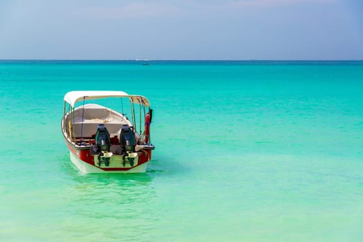 Turquoise Caribbean water as seen from Playa Blanca near Cartagena Colombia with a boat in the foreground