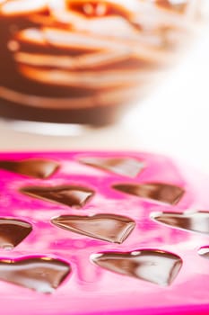 Warm chocolate just poured into chocolate mold.