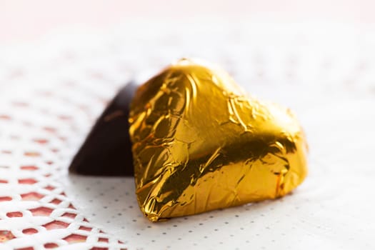 Two hearts, one wrapped in gold foil, one hidden.