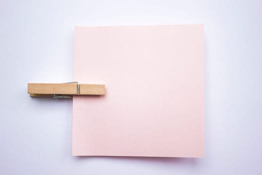 A reminder note pinned with a wooden peg on the side.