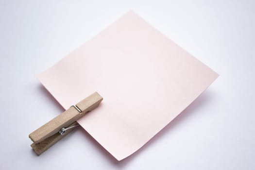 A reminder note pinned with a wooden peg on the side.