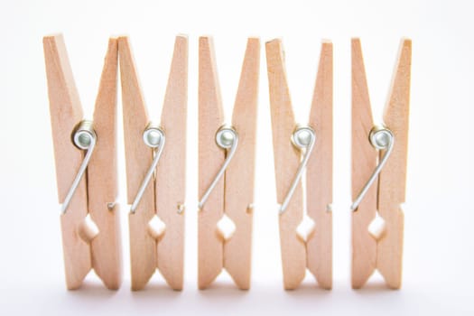 Composition of several wooden pegs on a white background.