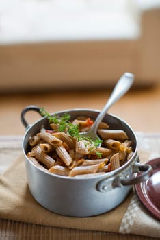 Whole grain pasta with tomato sauce close up shoot