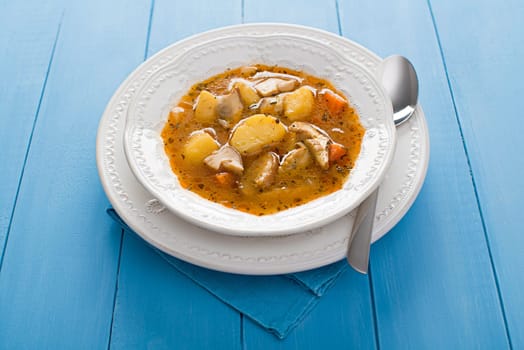 Hot mushroom soup decorated on blue background