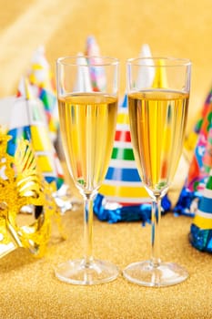 Masquerade Mask with champagne and party hat. Happy New Year.