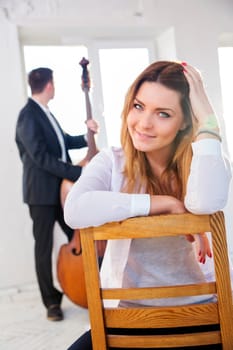 Young woman on wooden chair smile on camera