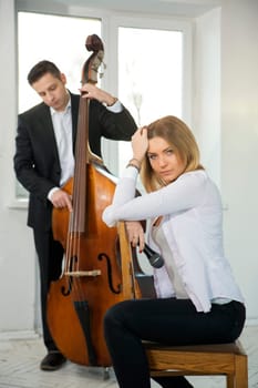 Woman backwards on wooden chair adjust long hairs