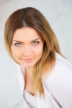 Focused look of pretty woman in white suit