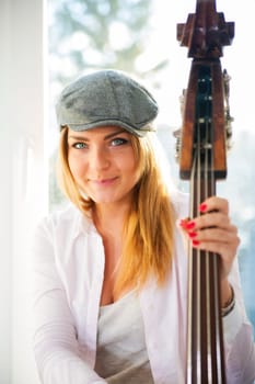 Charming woman with hat and strings  of contrabass