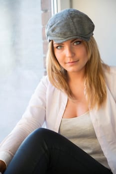 Charming woman in white suit and grey hat