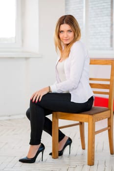 Charming woman in white suit with serious look