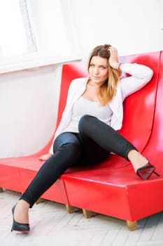 Charming woman in white upper suit waiting someone