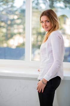 Charming woman in white suit with modest smile