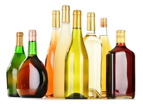 Bottles of assorted alcoholic beverages isolated on white background