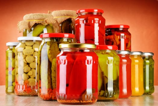Composition with jars of pickled vegetables. Marinated food