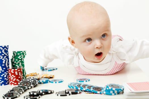 beautiful half-year-old baby playing with playing chips