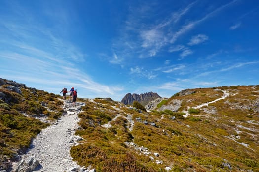 Hikers reaching the summit of a ridge with Cradle Mountain in background (Tasmania)