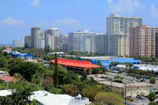 FORT LAUDERDALE, FLORIDA - APRIL 16, 2013: Colorful high up view of high-rise condominiums and other coastal buildings along the shore and inland north of Oakland Park Boulevard on a humid morning.