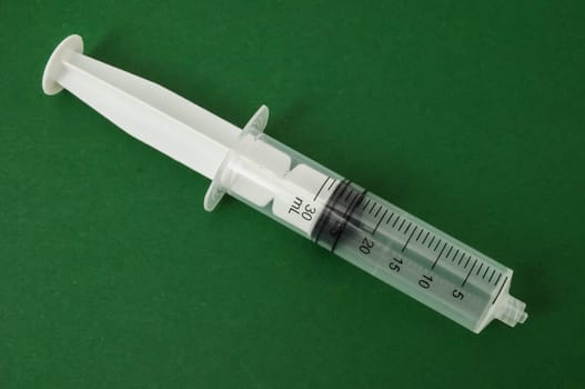 Big Black and White Syringe on a Colored Background