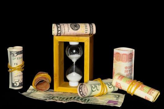 Buisness Time Concept Hourglass and Money on a Black Background