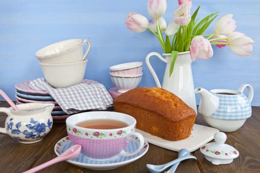 Sand cake and tea on colourful dishes