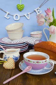 Sand cake and tea on colourful dishes