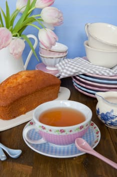 Sand cake and tea on colourful dishes