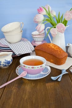 Sand cake and tea on colourful dishes