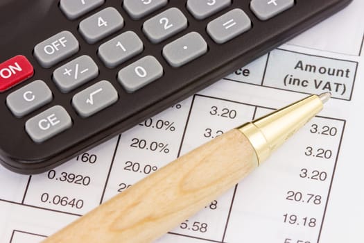 Calculator, pen and invoice with balance due