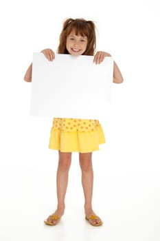 Full length front view of cute little girl holding blank sign on white background.