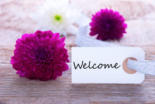 Label with Welcome and Purple and White Flowers