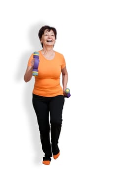 Smiling senior fitness woman excercising with barbells - isolated on white