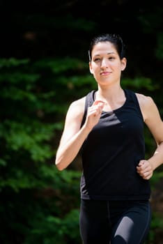Running for health - young woman jogging in nature