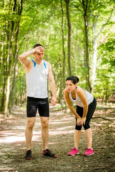 Sport couple very tired after sporting relaxing in nature (forest)