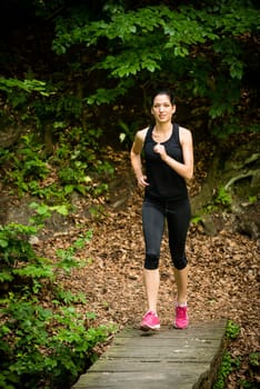 Running for health - young woman jogging in nature
