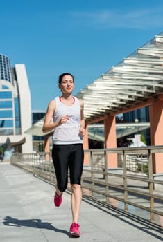 Running lifestyle - young sport woman jogging in street
