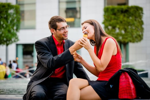 Sharing icecream - young business people having great time together outdoor