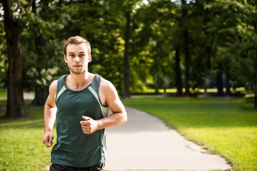 Jogging lifestyle - young attractive man running in park