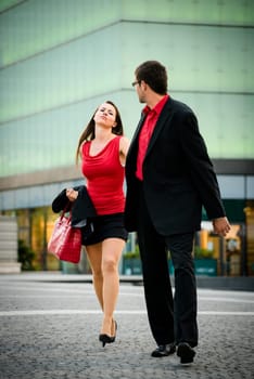 Hurry - young business man draging her girlfriend on street