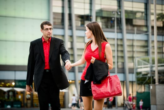 Hurry - young business woman draging her boyfriend on street