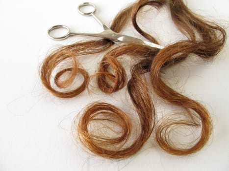 Real maroon hair and scissors