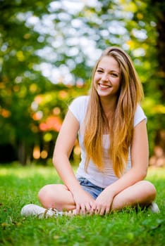 Portrait of young beautiful woman (teenage girl) - outside on grass