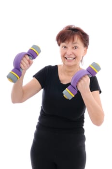 Smiling senior fitness woman with barbells