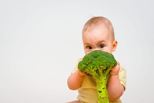 Cute baby eating broccoli - impact on eyes