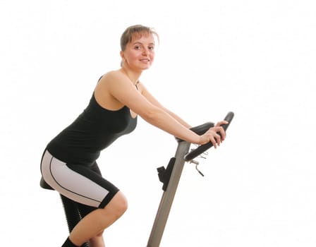 Young fitness woman exercising on spinning bicycle from back - isolated on white background