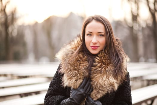 Beautiful lady is walking in the park in autumn